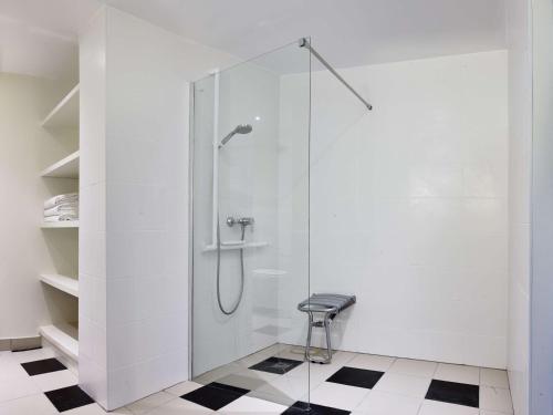 a bathroom with a shower with a stool in it at Radisson Blu Hotel Paris, Marne-la-Vallée in Magny-le-Hongre