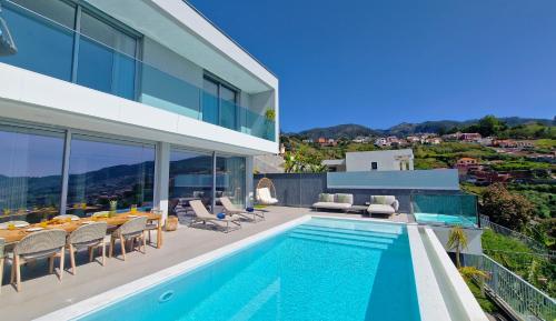 a villa with a swimming pool and a house at Villa Obra-Prima by LovelyStay in Funchal