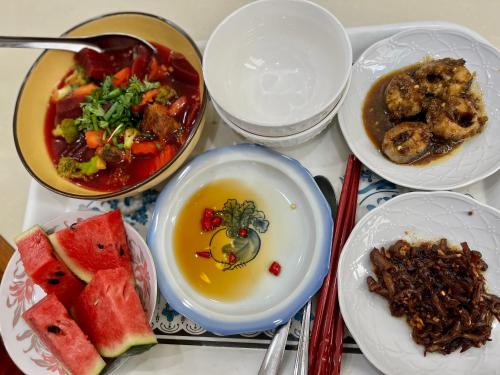 a group of bowls of food on a table at Cherry Homestay - Hoàng Đế motel in Chau Doc