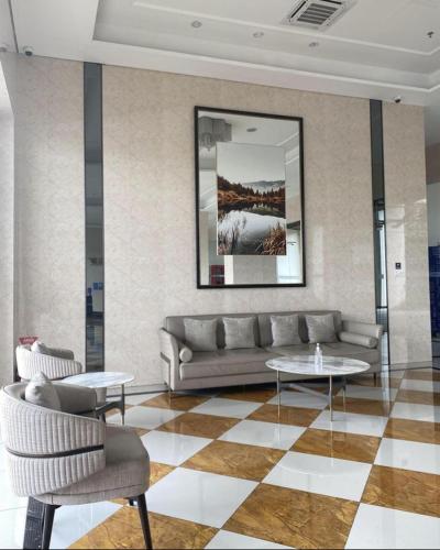 a living room with a couch and two tables at APARTEMEN SERPONG BSD in Samporo
