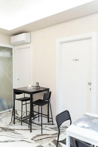 a dining room with a black table and chairs at Tom Luxury Home in Fondi