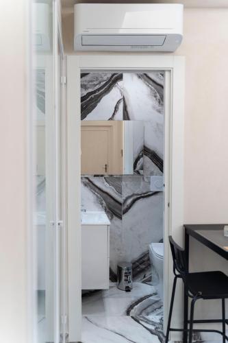 a bathroom with a sink and a toilet at Tom Luxury Home in Fondi