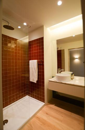 a bathroom with a tub and a sink and a mirror at Quinta do Fundo in Mondim de Basto