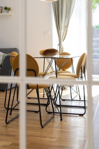 a table and chairs in a living room at New Modern Apartment in Podstrana With Garden Jacuzzi Is available from May 1st until September 30th in Podstrana