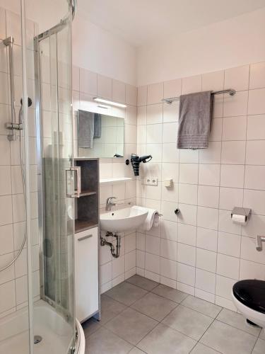 a bathroom with a sink and a shower and a toilet at Apartment Studio & Family - Adler Resort in Kaprun