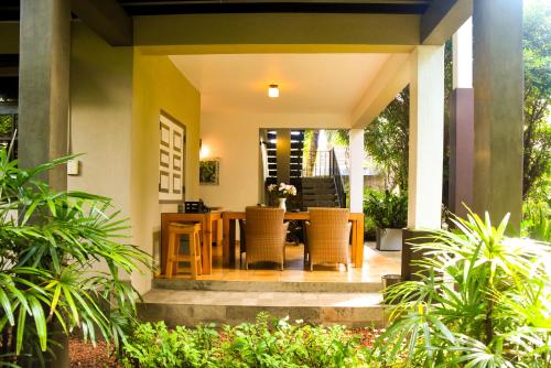 a porch with a table and chairs in a house at Sithu Villa Hikkaduwa in Hikkaduwa
