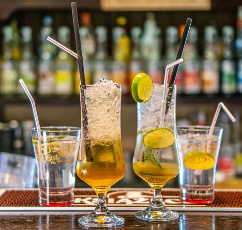 a group of three cocktails sitting on a bar at Zefir SPA in Polańczyk