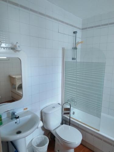 a white bathroom with a toilet and a sink at Lamedos in San Luis de Sabinillas