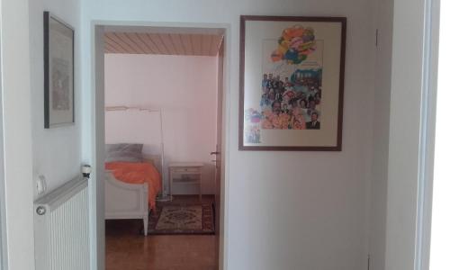 a bedroom with a bed and a picture on the wall at taunus in Königstein im Taunus