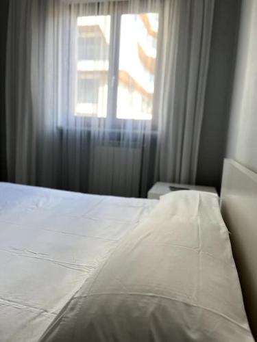 a white bed in a bedroom with a window at Sun-kissed seaside retreat: your Pescara getaway in Pescara