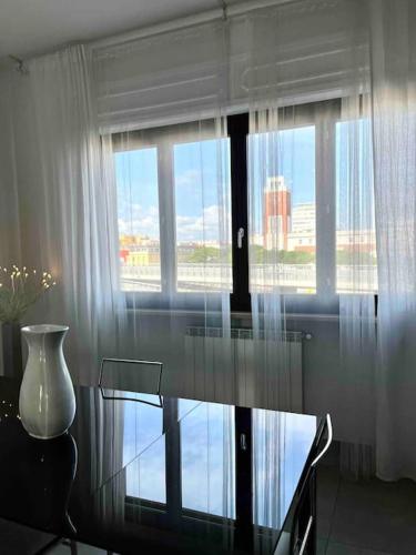 a glass table in a room with a window at Sun-kissed seaside retreat: your Pescara getaway in Pescara
