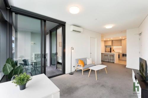 a living room with a couch and a table at Cozy 1 bedroom at Olympic Park with one carspace in Sydney