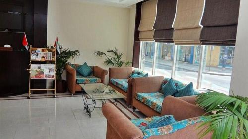 a living room with couches and a large window at Metro Single beds boys room next to Union Metro Station in Dubai