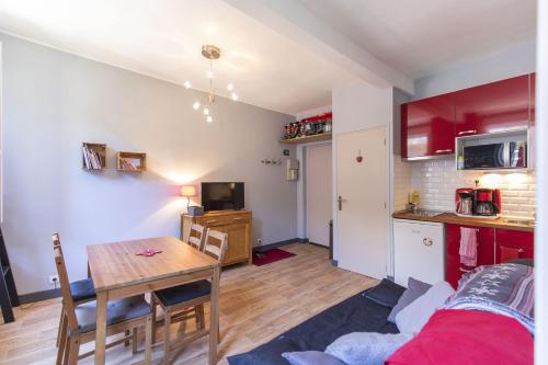 un salon avec une table de salle à manger et une cuisine dans l'établissement Cauterets Georgina, à Cauterets