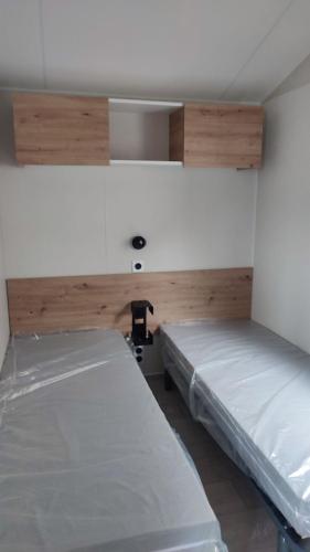 a room with two beds in a room at Tiny house camping Ambon in Ambon