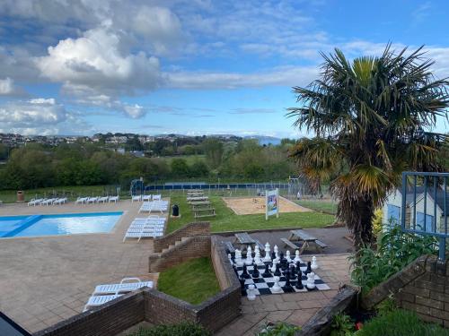a swimming pool with a chess board and a chess at Caravan on luxury Devon holiday park in Paignton