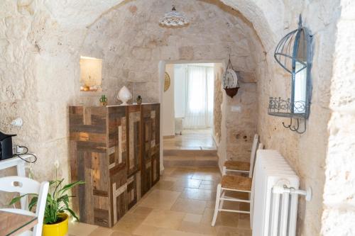 a room with a hallway with a stone wall at Trullo dei Sogni con Piscina e Jacuzzi in San Michele Salentino