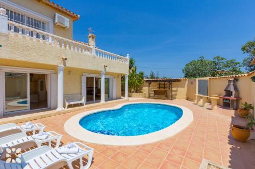 an image of a swimming pool in the backyard of a house at Villa Delicia by Abahana Villas in Calpe