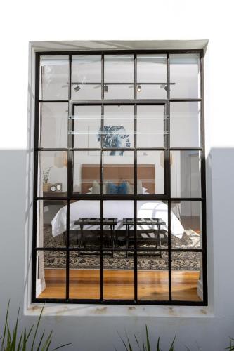 a window in a room with a bed at La Maison On Main Self-Catering Villa in Paarl