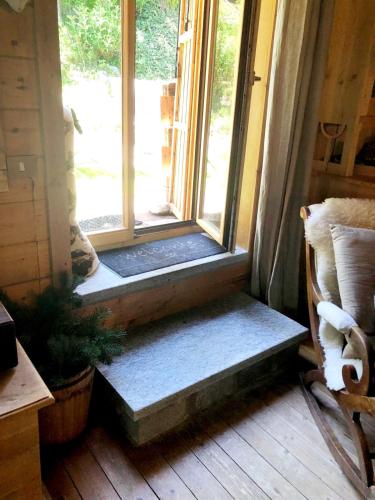 a window in a room with a bench in front of it at "CHALET dei FIORI" room & apartment in Bedretto
