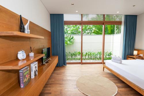 a bedroom with a bed and a large window at 5BedRooms Villas, Experience the luxury vacation The Ocean Estates in Da Nang