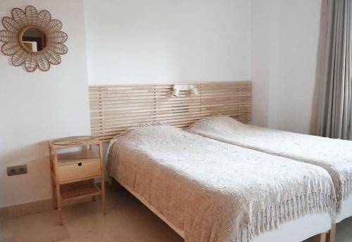 a bedroom with a bed and a table and a mirror at La Resina 3BD 2 BTH - SUN&RELAX in Estepona