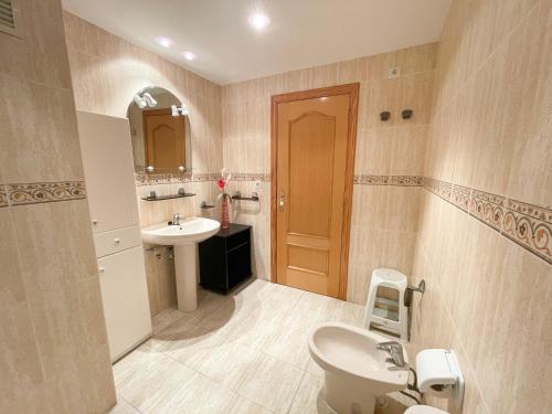 a bathroom with a toilet and a sink at Apartamentos Canet de Berenguer 3000 in Canet de Berenguer