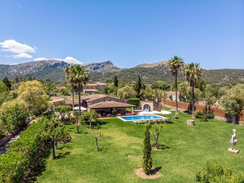 an aerial view of a yard with a pool and palm trees at Villa Alyvos Pollensa - BY EMERALD STAY in Pollença