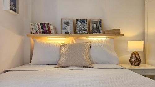 a bedroom with a bed with a shelf above it at Rinio House in Adamas in Mytakas
