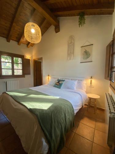 a bedroom with a large bed and a table at Molino del Corregidor in San Román de Cameros