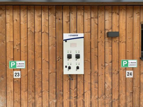 a parking meter on a wooden fence at Haus am Sonnenhang by Schladming-Appartements in Schladming