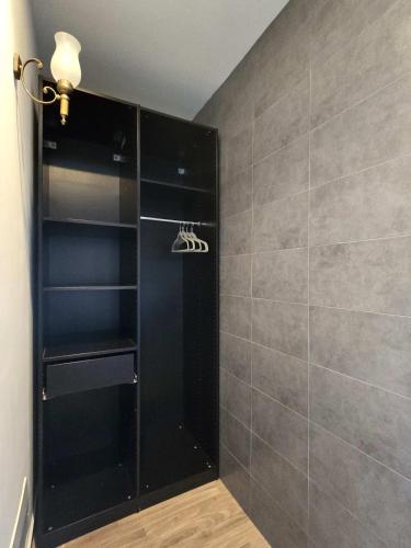 a walk in shower with a black cabinet in a bathroom at Art Garage Varese in Biandronno