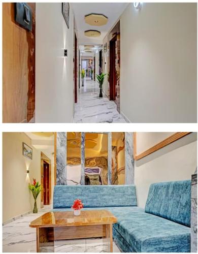 艾哈邁達巴德的住宿－HotelMeetPalace，客厅配有蓝色的沙发和桌子