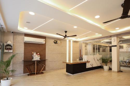 a lobby with a ceiling fan and a reception desk at Arjun - A boutique hotel in Haridwār