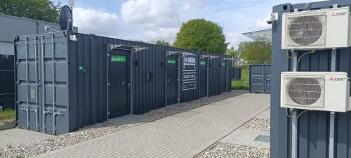 a row of portable toilets sitting next to a building at Roatel Busdorf A7 my-roatel-com in Busdorf