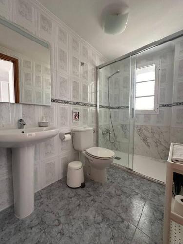 a bathroom with a toilet and a sink and a shower at Apartamento Alisio in Arrieta