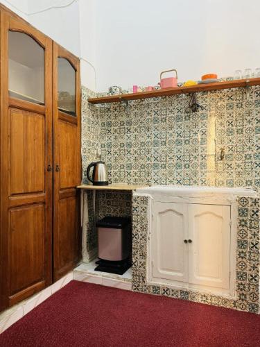 een keuken met een aanrecht en een deur en een keuken bij Bel appartement in Tunis