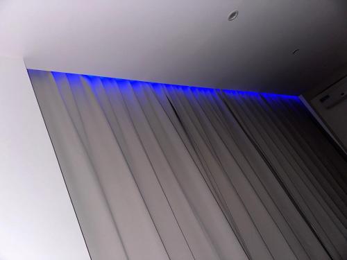 a blue curtain in a room with a ceiling at Sharksproperties Apartment in Mindelo