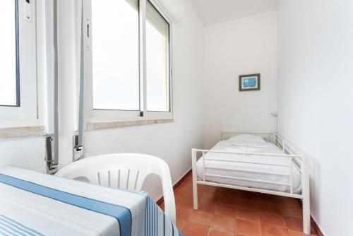 a hospital room with two beds and two windows at Blife Faro Beach Hostel & Rooms in Faro