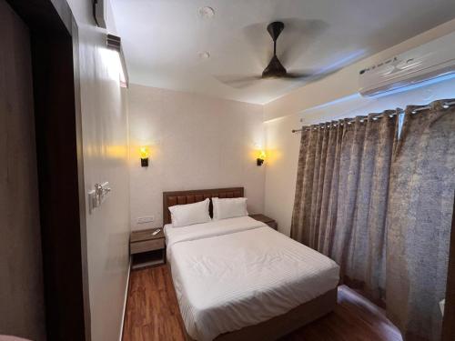 niewielka sypialnia z łóżkiem i sufitem w obiekcie The Lake Palm Hotel w mieście Kolkata