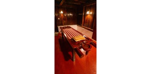 a room with a bench with a book on it at Kumarakom Heritage Resort & Ayurveda in Alleppey