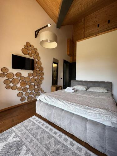 a bedroom with a bed and a wall with logs at Girske Povitria 2 in Yaremche