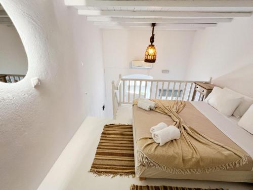 a bedroom with a bed and a rug at Kamara Residence & Suites in Mýkonos City