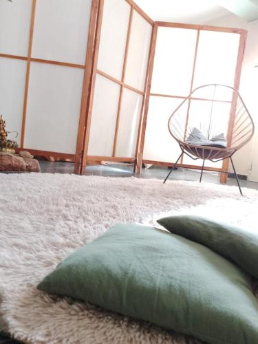 Habitación con cama con almohada y silla en Como en Casa en Comodoro Rivadavia