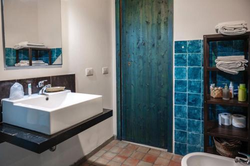 a bathroom with a white sink and a shower at La Virgy per Noto with share swimming pool with woderful seaview in Avola