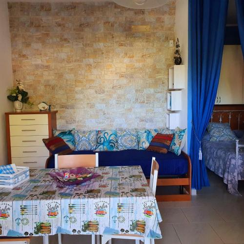 a living room with a table and a couch at Salento - A Casa di Lilli in Porto Cesareo