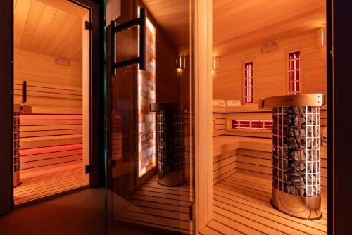 a japanese sauna with a glass door at Belmar Park Resort & SPA in Władysławowo