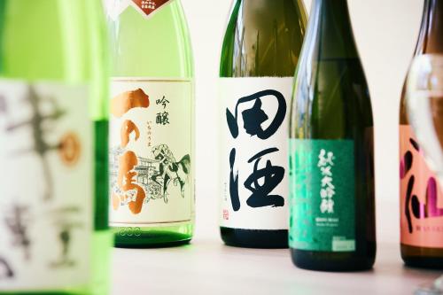 a group of four bottles of wine on a table at Tsubakikan in Aomori