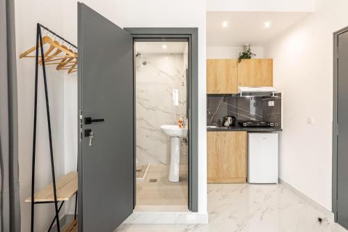 a kitchen with a door open to a kitchen with a sink at Fysalida's Coastal Gem 3 - Steps Away from the Sea in Amoudara Herakliou