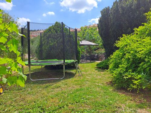 a swing in the grass in a yard at Greta in Vrbnik